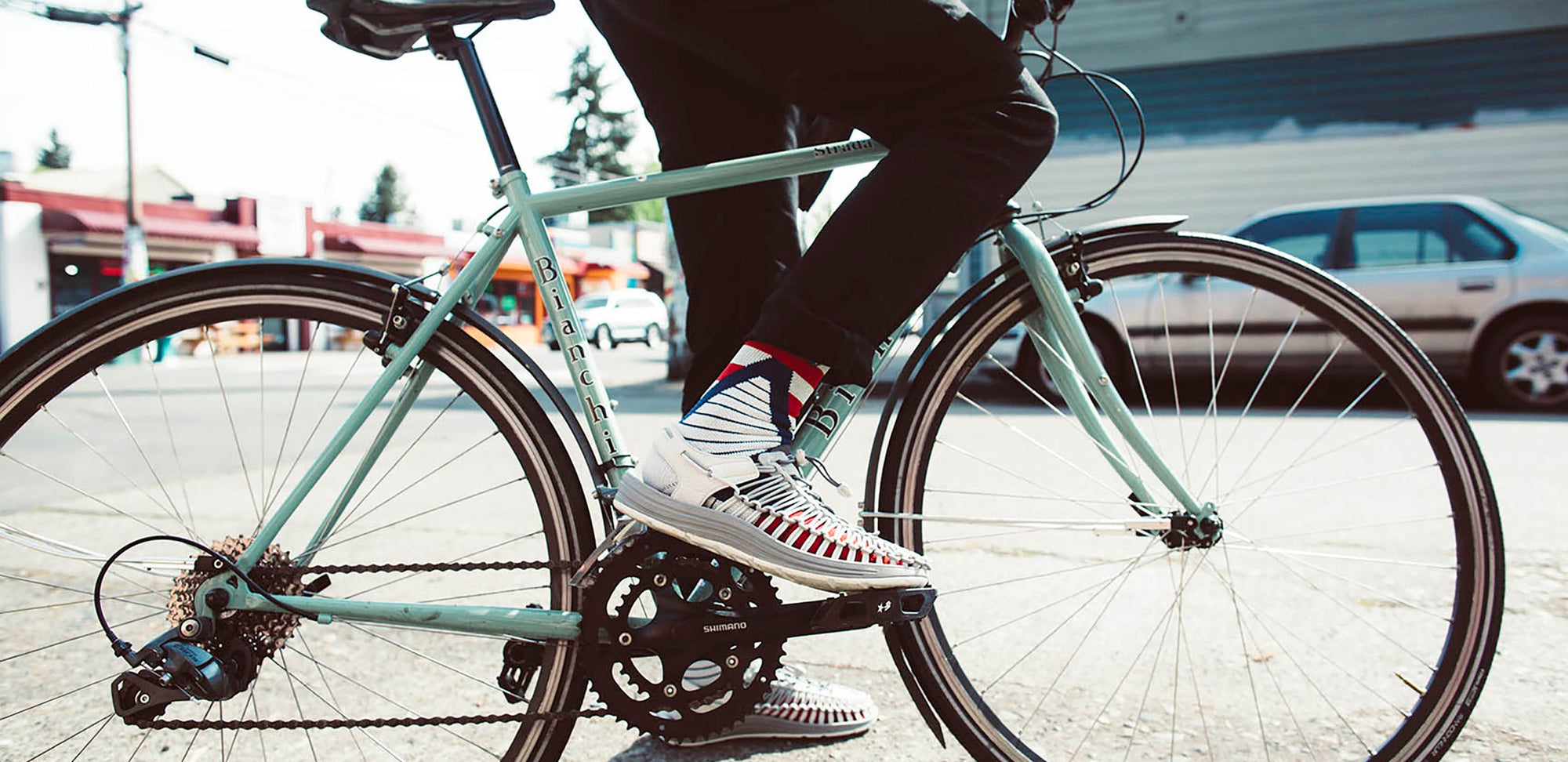 A person riding a bike in socks & sandals