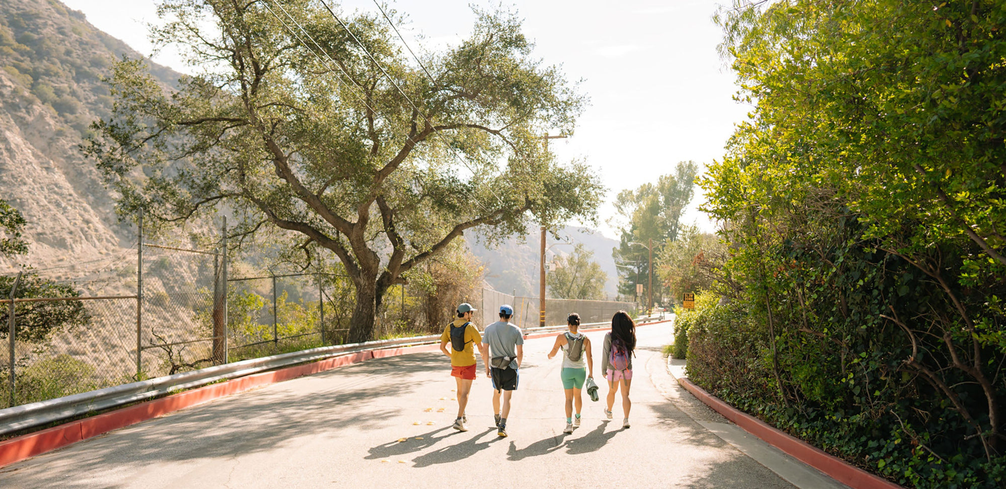 a group of people walk down a road together